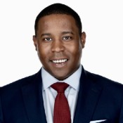 black man smiling in red tie