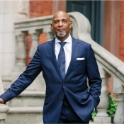 black man in navy suit