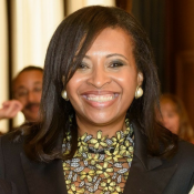 BLACK WOMAN SMILING IN FLORAL BLOUSE